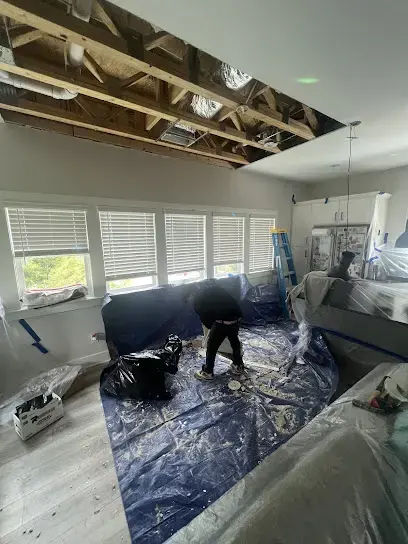 Ceiling opened and furniture covered while a room dries